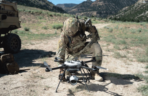 A military member preparing the SkyRanger R70 to fly