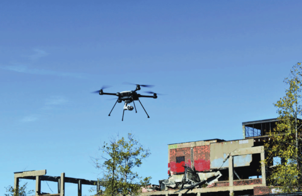 The SkyRanger R70 flying next to an abandoned building