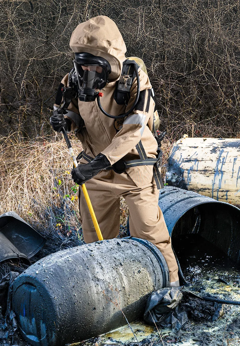 Responder in a Khaki Kappler DuraChem 500 suit with SCBA working at leaking drums