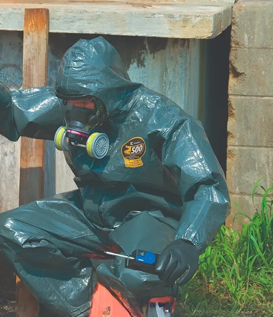 Worker in a charcoal gray Kappler Zytron 500 hooded coverall